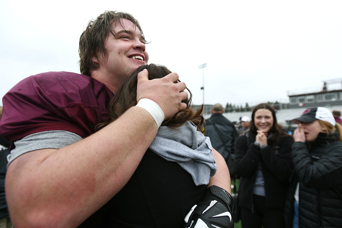 Montana Grizzlies offensive lineman Cy Sirmon (66) hugs his new fiancee Lauren Heiser after he proposed at midfield after the Spring Game at Legends Stadium in Kalispell on Saturday. (Casey Kreider/Daily Inter Lake)