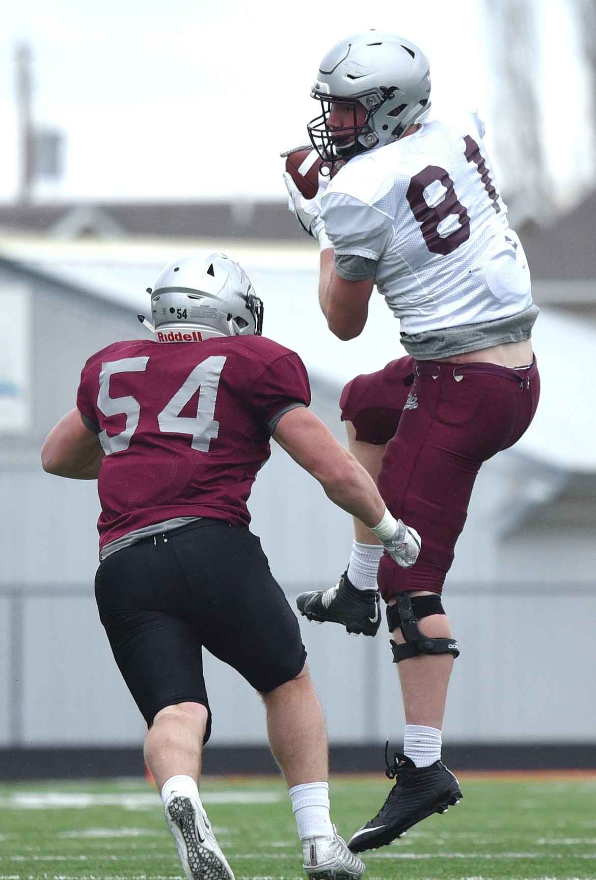 Montana Grizzlies tight end Matt Rensvold (81), from Polson High School, hangs on to a reception in front of linebacker Tyler Flink (54) during the Spring Game at Legends Stadium in Kalispell on Saturday. (Casey Kreider/Daily Inter Lake)