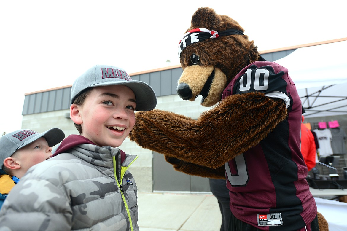 Owen Dodrill, 10, of Whitefish, is all smiles after getting his hat signed by Monte, the Montana Grizzlies mascot, before the start of the Spring Game at Legends Stadium in Kalispell on Saturday. (Casey Kreider/Daily Inter Lake)
