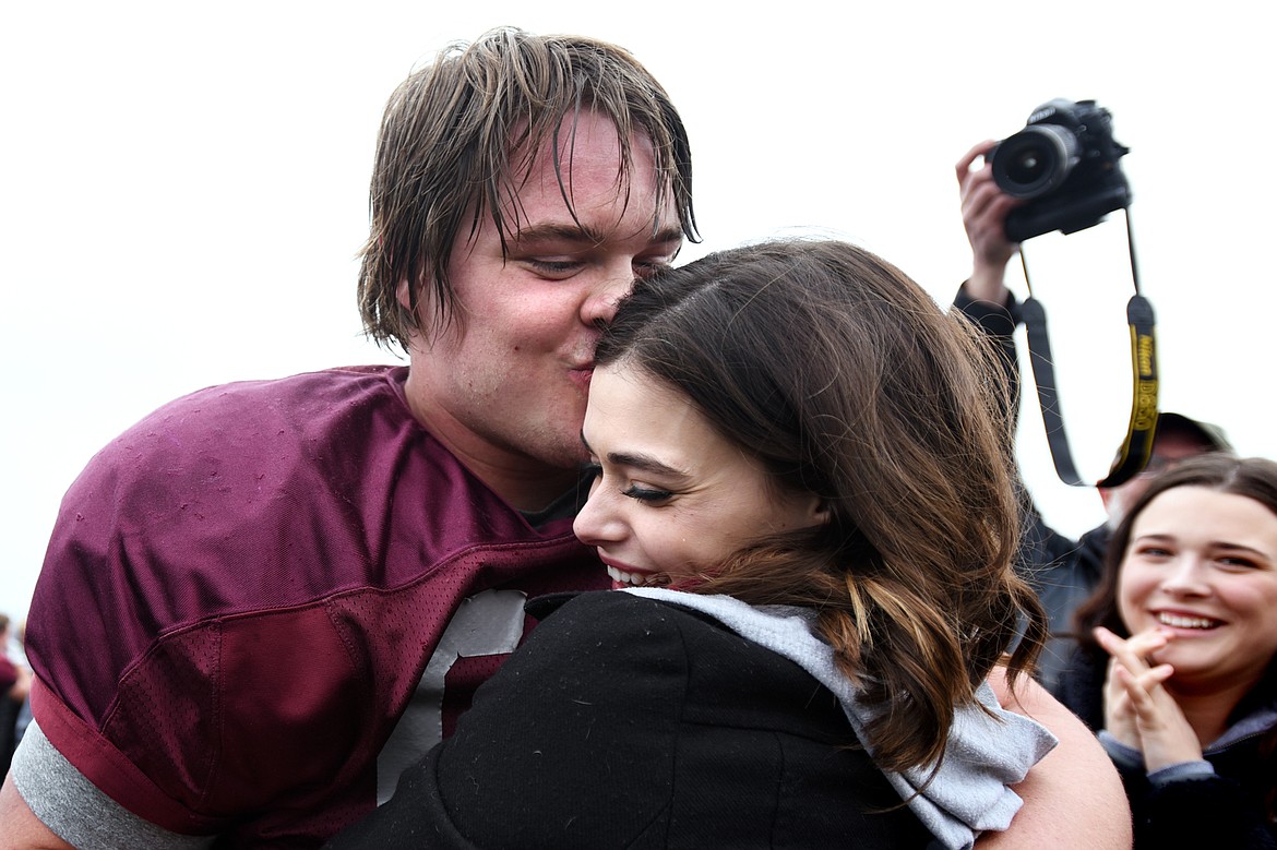 Montana Grizzlies offensive lineman Cy Sirmon (66) gives a kiss to his new fiancee Lauren Heiser after he proposed at midfield after the Spring Game at Legends Stadium in Kalispell on Saturday. (Casey Kreider/Daily Inter Lake)