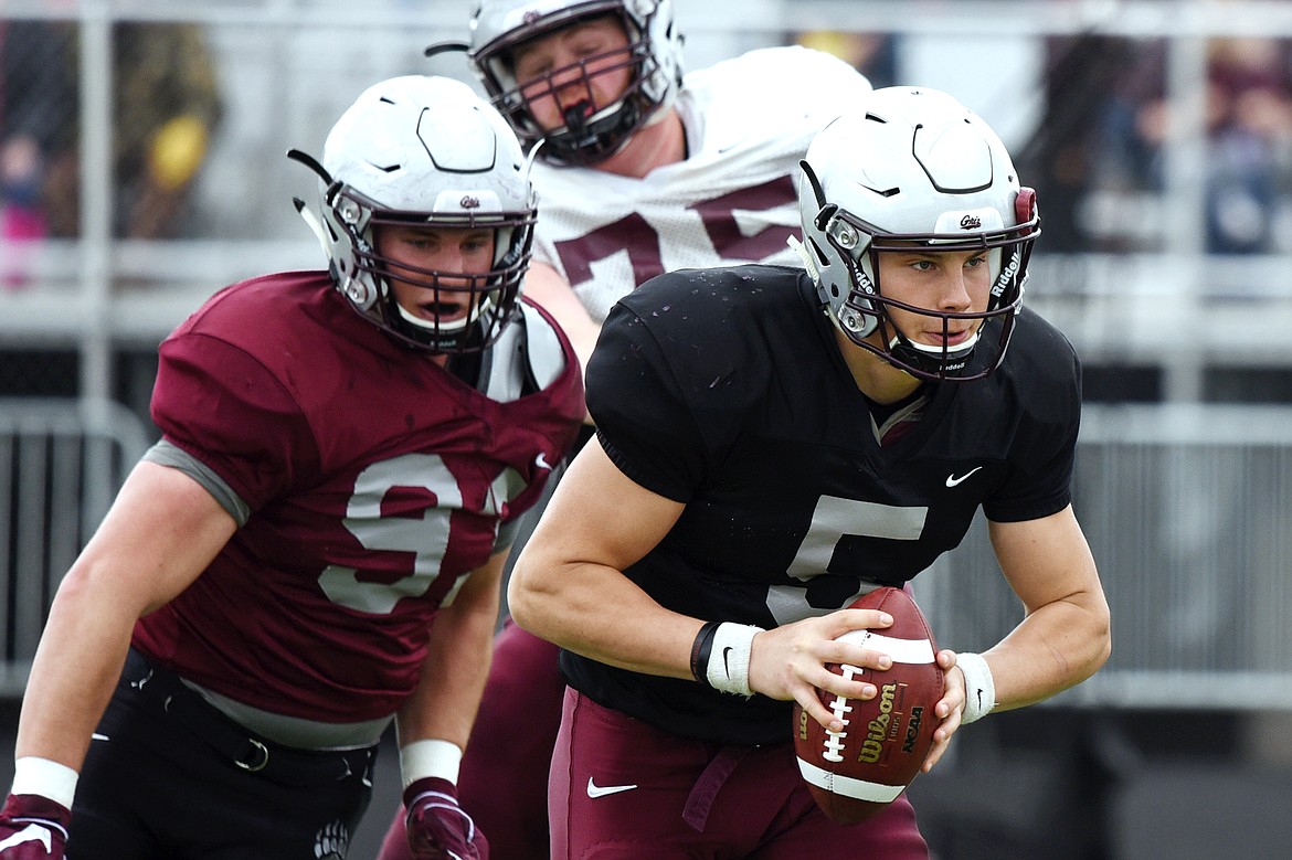 Montana Grizzlies quarterback Garrett Graves (5), from Lincoln County High School, looks to throw as he's flushed from the pocket by Braydon Deming (93) during the Spring Game at Legends Stadium in Kalispell on Saturday. (Casey Kreider/Daily Inter Lake)