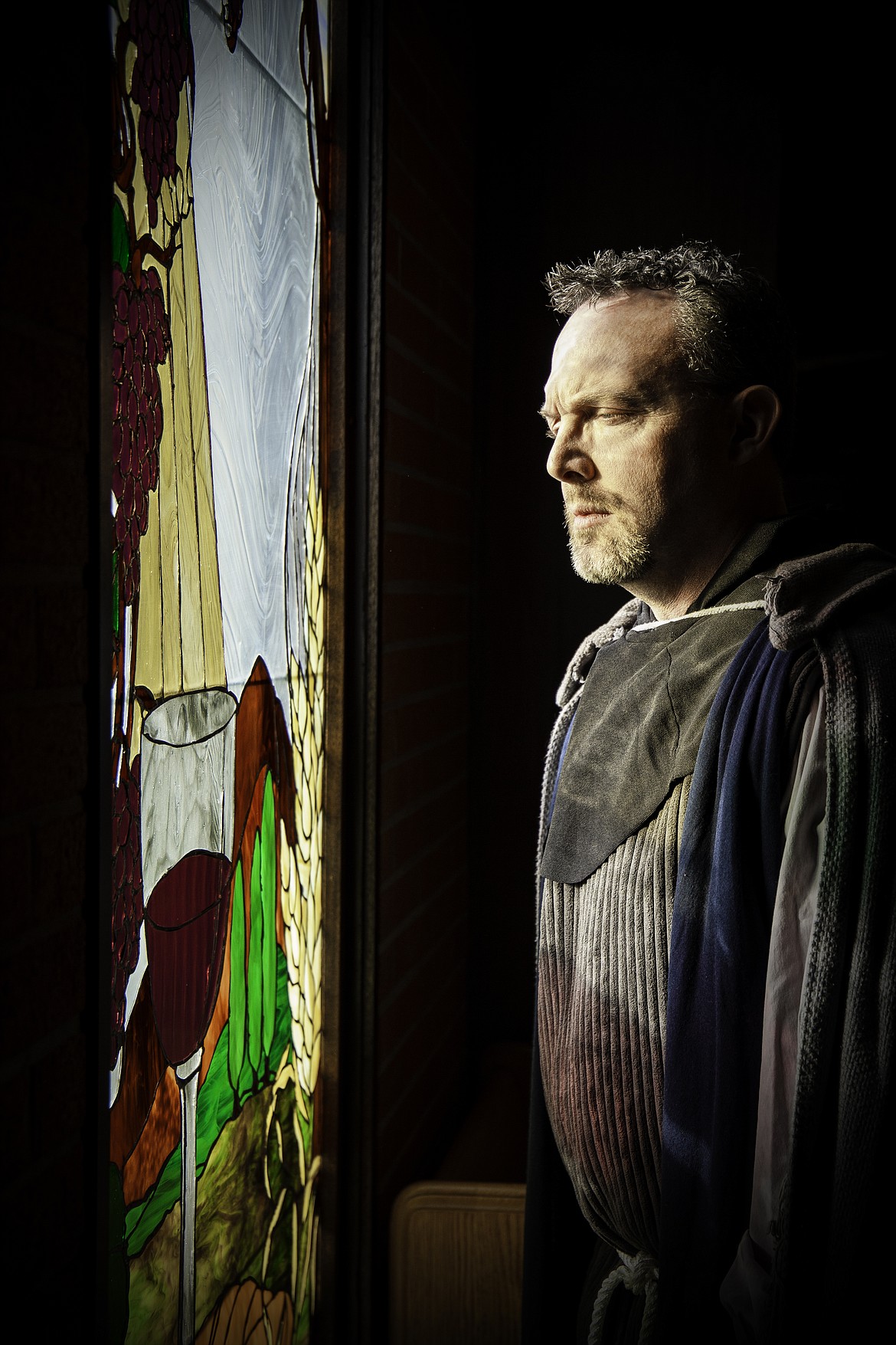 A gloomy Frollo, played by Greg Washington, stares out a window in a scene from Aspire Community Theatre's upcoming production of &quot;The Hunchback of Notre Dame.&quot; 
(Photo by PRESERVATION PHOTOGRAPHY)