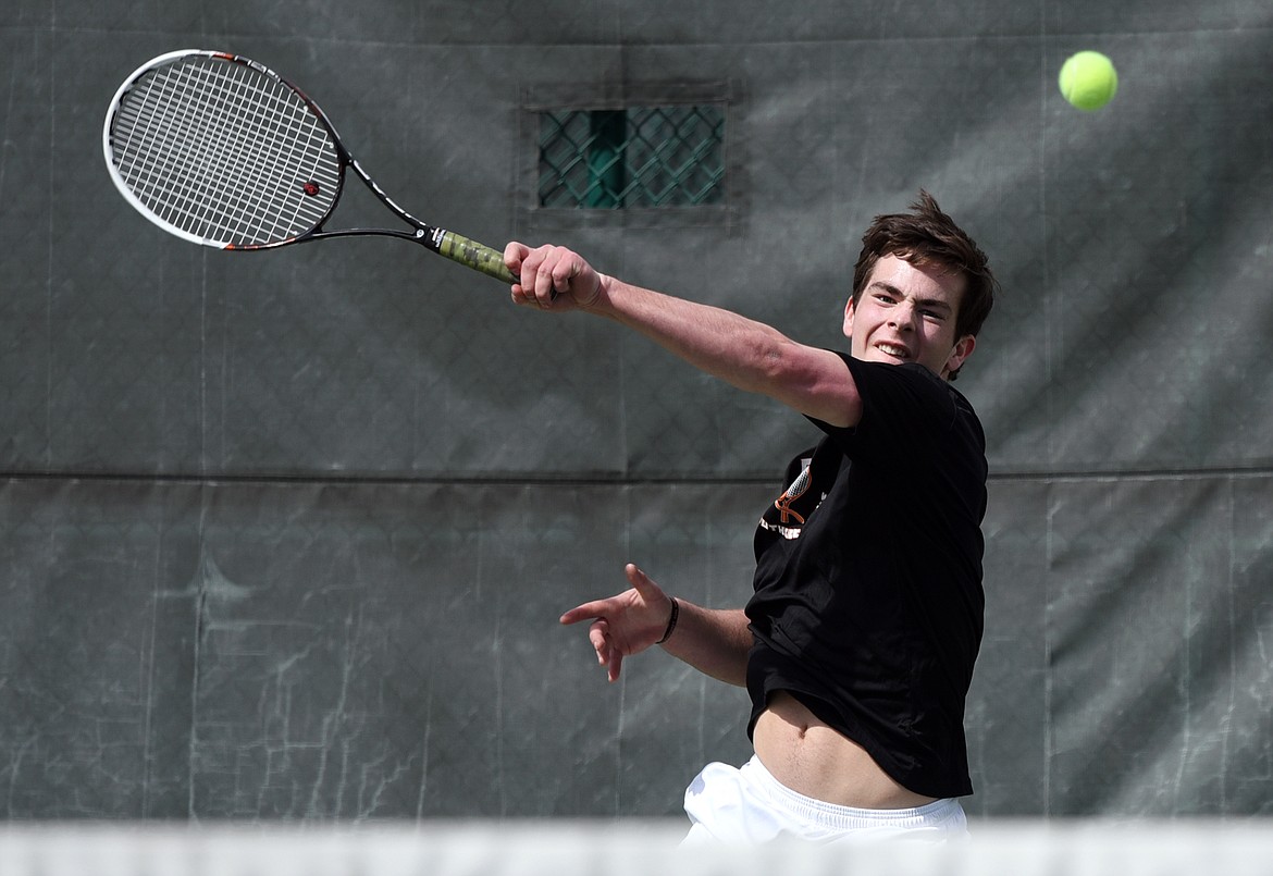 Flathead's Nolan White hits a return against Glacier's Rory Smith during a crosstown tennis match at Flathead Valley Community College on Friday. (Casey Kreider/Daily Inter Lake)