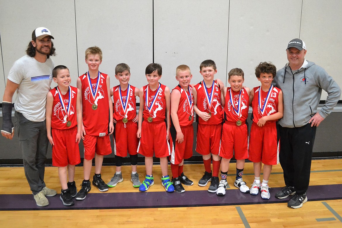 (Photo courtesy of JOHN AEXEL)
The Sandpoint Future fourth grade boys AAU team celebrate after winning the Rally in the Valley Tournament. Standing from left to right are: coach Chase Williams, Landon Brinkmeier, Derrick Chamberlain, Andrew Aexel, Joey Allen, Damian Porter, Brock Yarbrough, Logan Iverson, Knox Williams and coach John Aexel.
The boys went undefeated in the tournament by rallying from being down 13 points in the second half to force overtime and defeat the host Silver Valley Wildcats 32-28 in the opening game.
In the second game against North Idaho Elite, they rallied again from being down 18-8 at halftime and  then rolling in the second half to another 32-28 victory.  nd finally in the Championship Game against North Idaho Elite, the boys came out with a tenacious in-your-face defense from the start to force multiple turnovers, build a solid lead at halftime and then pull away for a 41-19 victory.
Steady guard play by Knox Williams and Andrew Aexel set the tone for the tournament, most notably with Brock Yarbrough and Derrick Chamberlain leading the scoring and controlling the boards. Landon Brinkmeier and Damian Porter were causing havoc by creating multiple turnovers, along with Logan Iverson and Joey Allen getting in on the scoring. The boys played solid in the Post Falls and Hayden Leagues this year; finishing the season with the tournament win was a fitting end to their solid season.