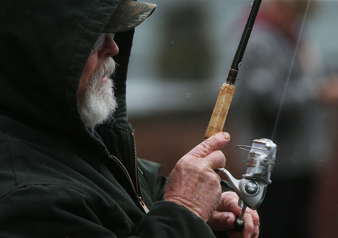 Chuck Knapp reels in a fish Tuesday afternoon at Fernan Lake. (LOREN BENOIT/Press)