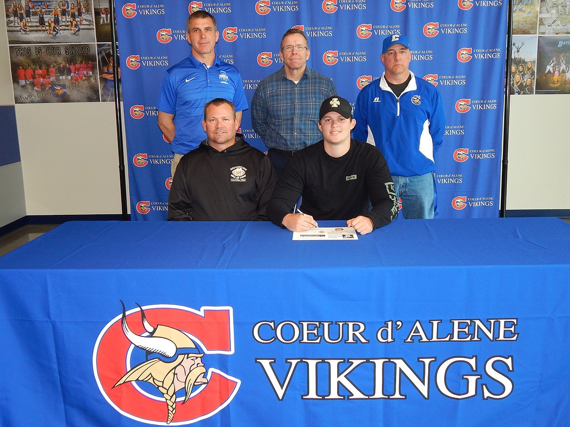 Courtesy photo
Coeur d&#146;Alene High senior Logan Nosworthy has accepted a preferred walk-on offer to play football at Idaho. Seated from left are Kelly Nosworthy (dad) and Logan Nosworthy; and standing from left, Derek Edwards, Coeur d&#146;Alene High assistant football coach; Mike Randles, Coeur d&#146;Alene High athletic director; and Shawn Amos, Coeur d&#146;Alene High head football coach.