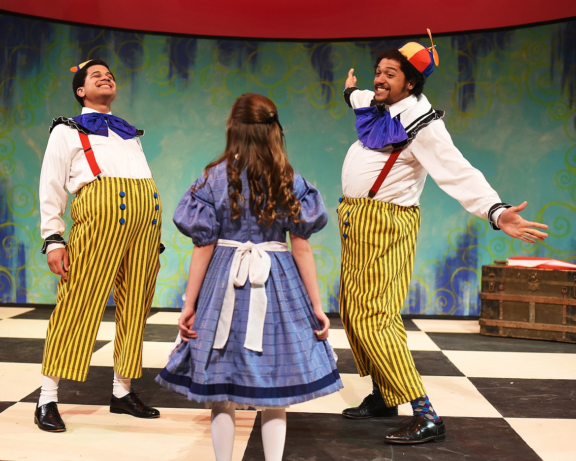 Adam and Aaron Robinson play the parts of Tweedledee and Tweedledum in the dress rehearsal for Alice in Wonderland on Tuesday night, April 9, at the Whitefish Theatre Company. Alice in the foreground is played by Simma Lefcourt.(Brenda Ahearn/Daily Inter Lake)