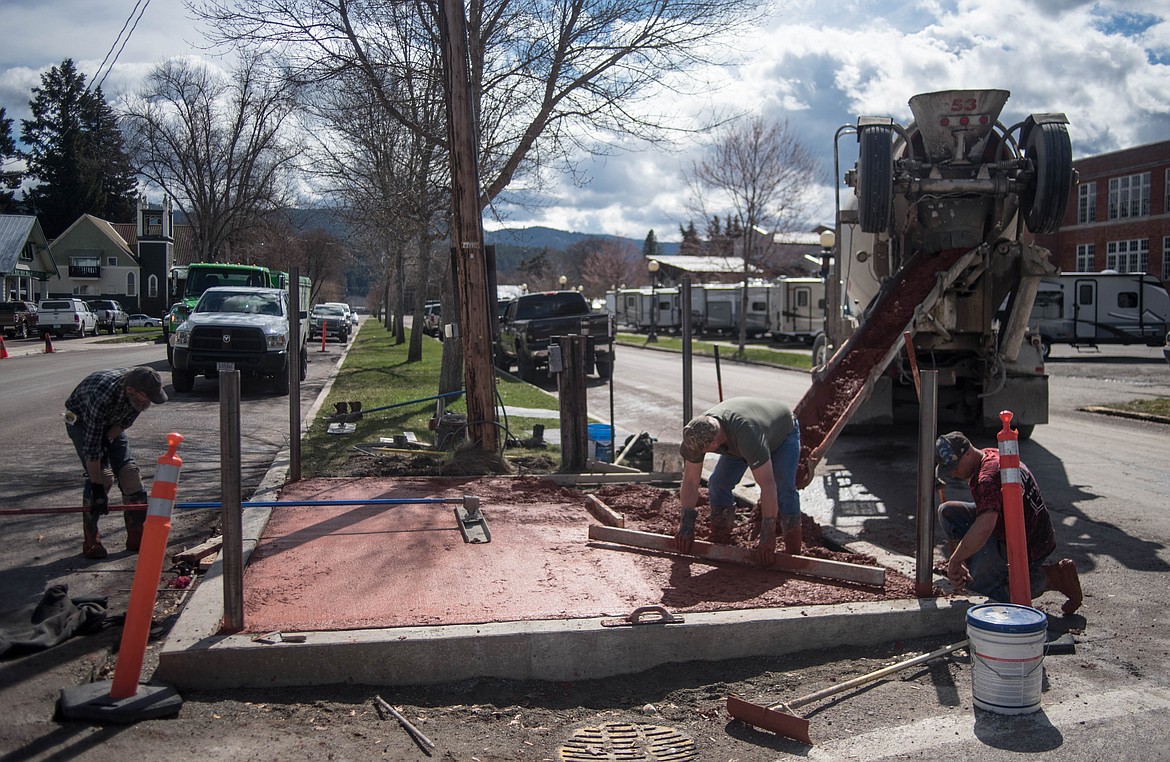 (From left to right) Ron Watkins, Chuck Riley and Dustin Tracey of Riley Excavating &amp; Concrete lay the cement foundation for Libby&#146;s WWI statue which is being refurbished, Wednesday on Lincoln Boulevard. (Luke Hollister/Ther Western News)