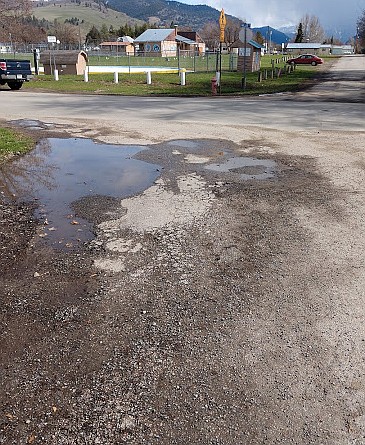 THE CORNER of Willis and Oak streets in Plains exemplifies the problem facing most of Plains' streets. Water pools and soaks into the roadbed, causing pavement to crumble. &quot;Once you understand what you're seeing,&quot; says Plains Mayor Dan Rowan, &quot;you see it everywhere.&quot; Willis Street is scheduled for ditching and pavement improvements this year. (Photos courtesy of Dan Rowan)