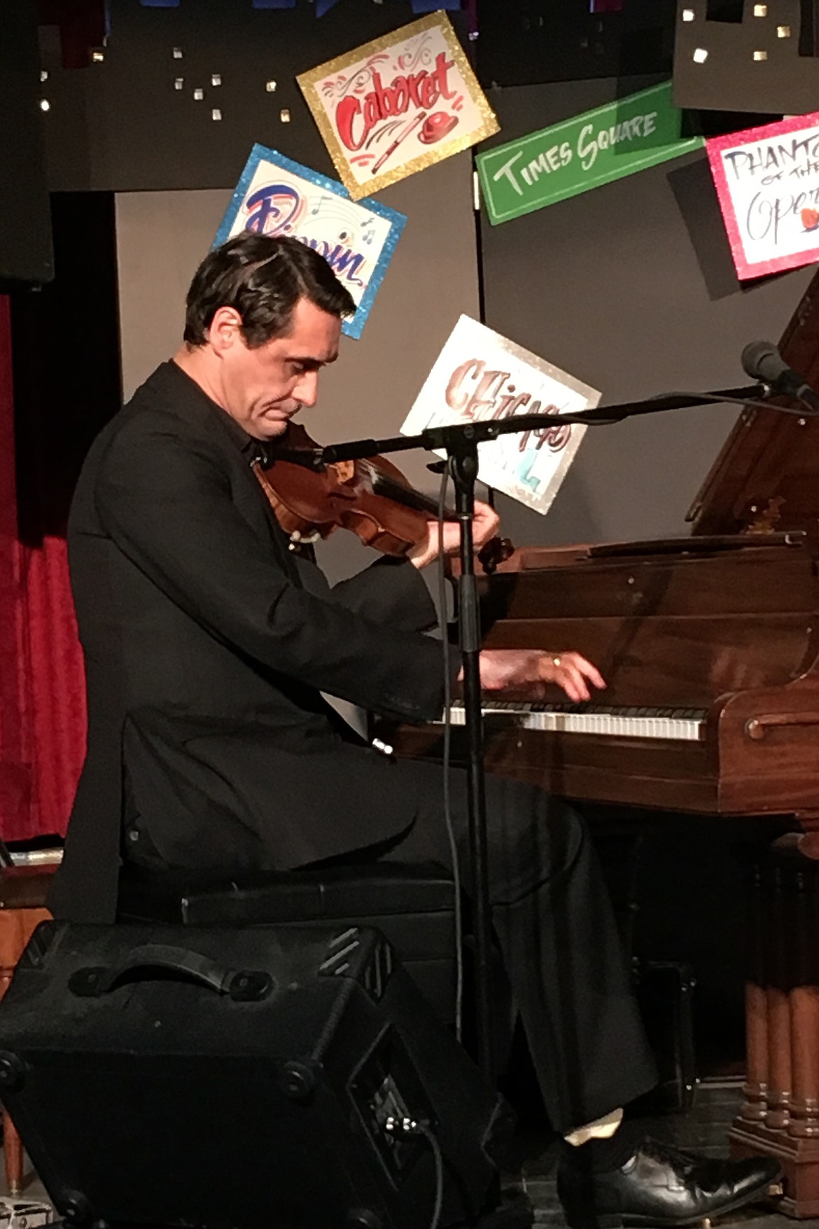 DAVID SHENTON delights the Paradise Center audience playing violin and piano at the same time during the O Sole Trio performance Saturday night, April 13.