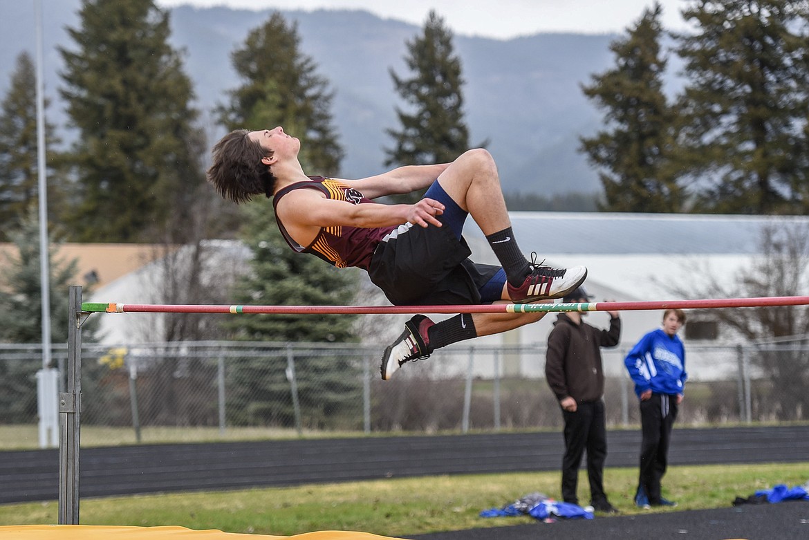 Troy sophomore Dyklan Peterson tucks his legs up as he clears the bar in the high jump Saturday at the Libby Invitational. (Ben Kibbey/The Western News)
