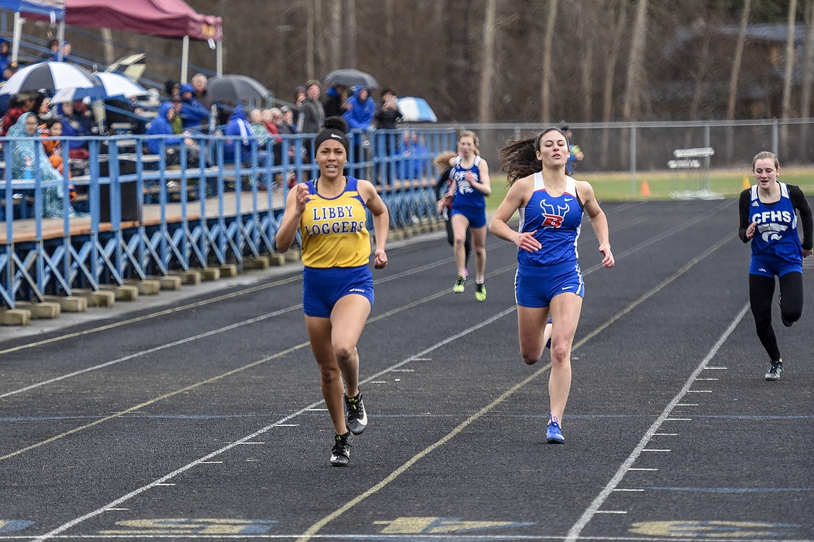 Libby sophomore Olivia Gilliam-Smith punches through for a first place finish, with a time of 13.77 seconds, in the 100 meter dash, Saturday at the Libby Invitational. (Ben Kibbey/The Western News)