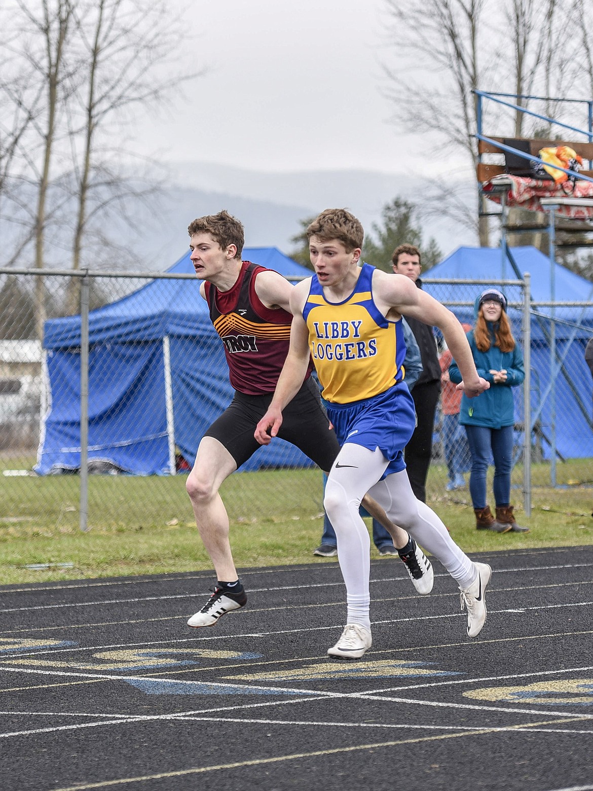 Troy senior Hunter Leighty and Libby sophomore Jay Beagle come close to a photo finish in the 400 meter dash, Saturday at the Libby Invitational. Beagle finished in a season-record 51.36 seconds, and Leighty took second with a personal-best 51.46 seconds. (Ben Kibbey/The Western News)