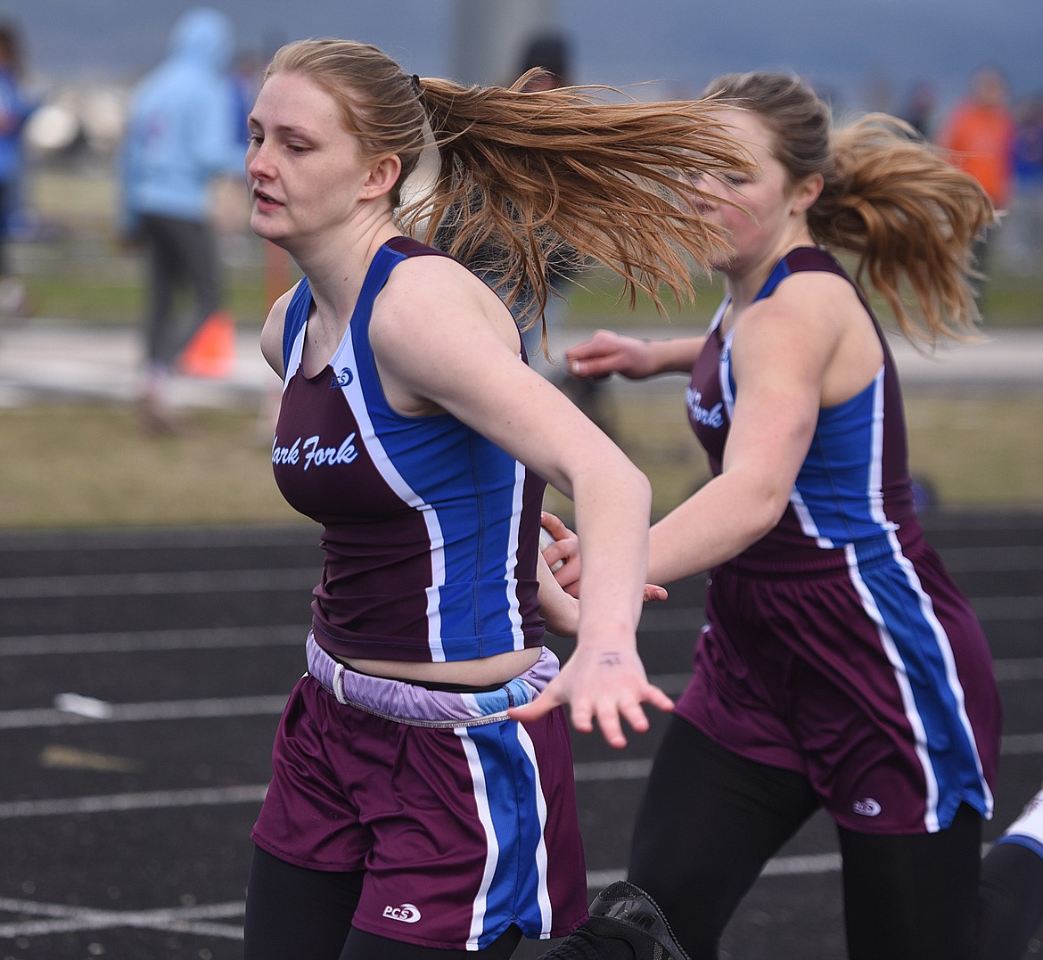 CLARK FORK Mountain Cat Cassie Green hands off to Emma Baughman on the final exchange in the 4x100-meter relay at the Dave Tripp Invitational in Polson on Friday, April 12. (Joe Sova photos/Clark Fork Valley Press)