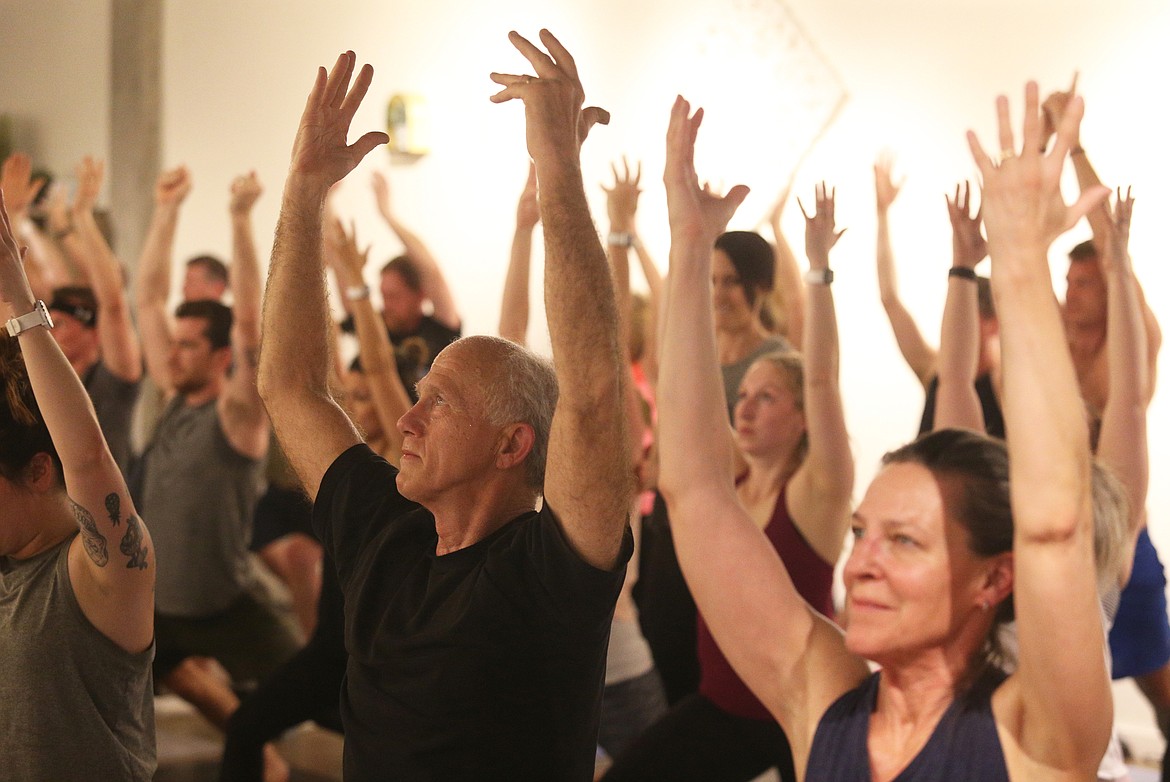 Tim Zasadny and his wife, Deaun,  participate in a heated Baptiste power yoga class on Tuesday in Riverstone. (LOREN BENOIT/Press)
