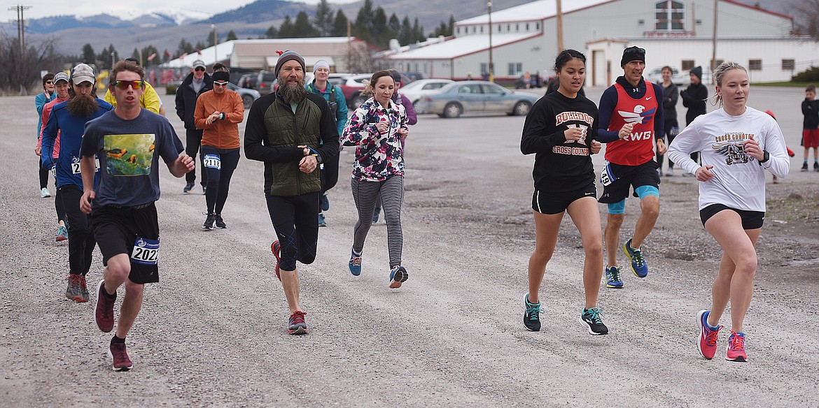 ABOUT 15 entrants get off the starting line of the Buttercup Run&#146;s half marathon race Saturday, April 13 at Arlee. Owen Pierre, wearing #2022 at left, was the race winner in 1:30:26.56. 
(Joe Sova photos/Lake County Leader)