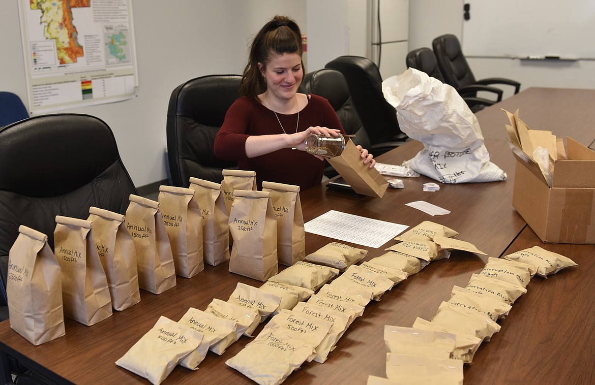 LAUREN ODOM packages free flower seeds for Lake County residents to help boost bee populations. (Carolyn Hidy/Lake County Leader)