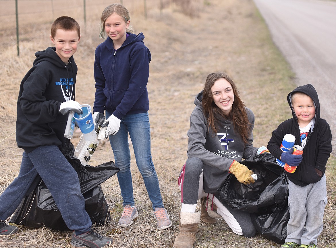 ABOUT 45 volunteers covering a wide age range gathered for the Arlee Community Development Corporation town clean-up Saturday, April 6. The focus was sprucing up the course for the annual Buttercup Run this Saturday, April 13. Pictured during the cleanup, from left, are Jocko Rangers 4-H Club members Brody and Bailey Smith, and Saige Koepter, and perhaps future 4-H member 3-year-old Boyd Smith. (Joe Sova photos/Lake County Leader)