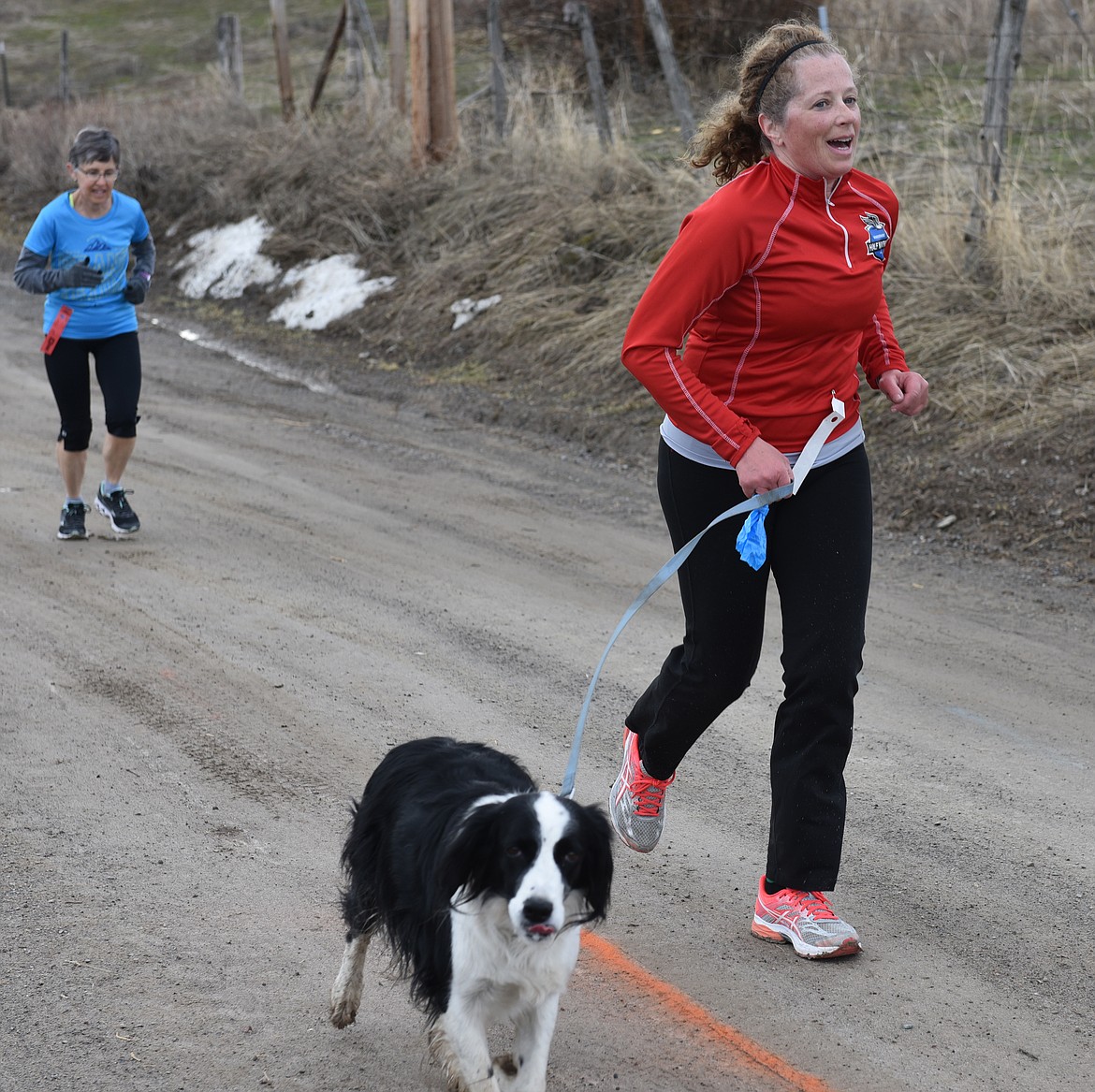 KATHY McENERY with running partner &quot;Lil&quot; and Pat Bristol on the Bench Road stretch of the 5K.