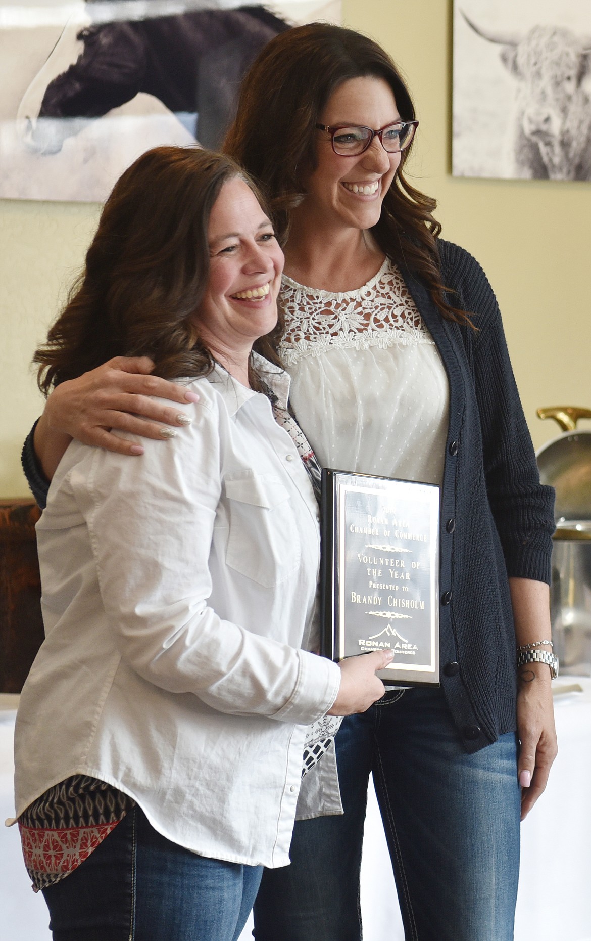 BRANDY CHISHOLM receives one of the two Volunteer of the Year awards from Ronan Chamber member Lacy Cates.