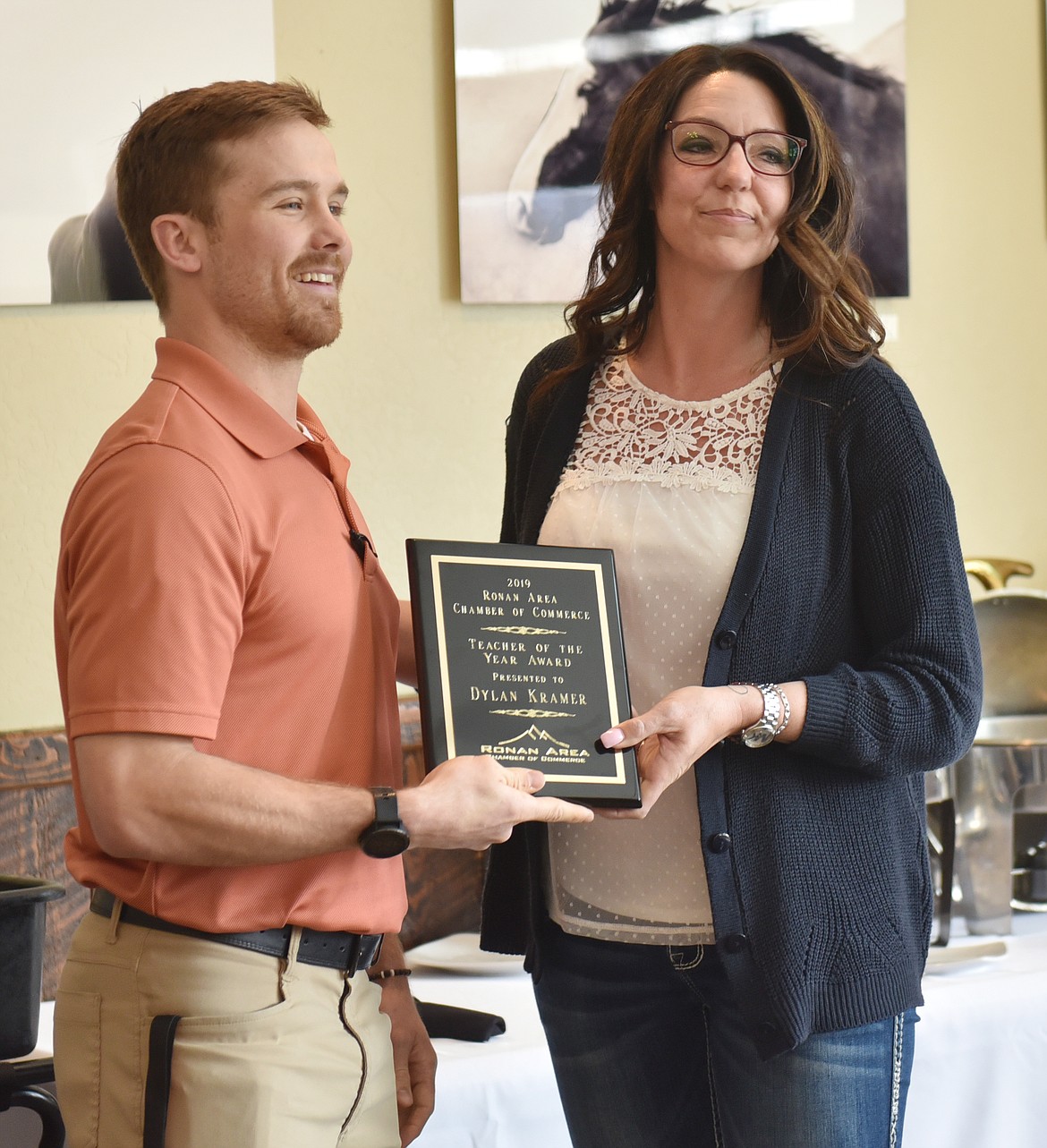 DYLAN KRAMER of Ronan High School received Teacher of the Year kudos from Ronan Chamber member Lacy Cates. Casey Lunceford (not pictured) was also honored as Teacher of the Year.