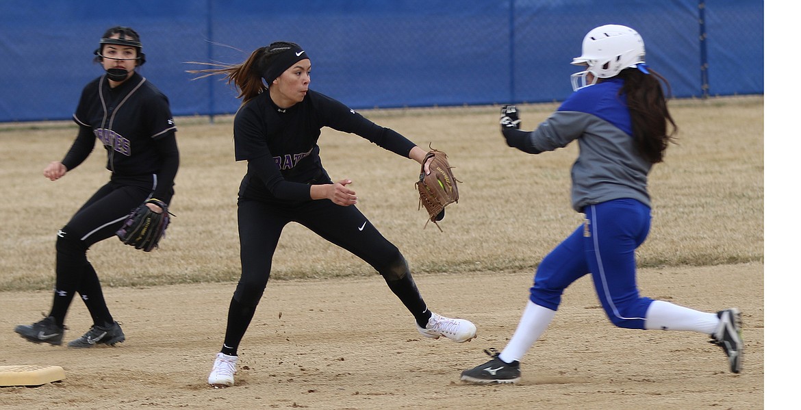 LADY PIRATE shortstop Josie Caye puts the tag on a Corvallis runner on a good throw from catcher Kaylanna DesJarlais in the season opening victory at Corvallis last weekend. (Bob Gunderson/Special to the Leader)