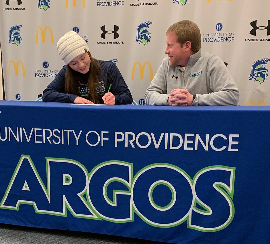 POLSON SENIOR Ashlee Howell signs her Letter of Intent to play women&#146;s soccer for the University of Providence Argonauts. Seated to her left is UP women soccer coach Brian Clarke. (Photo courtesy of Heidi Howell)