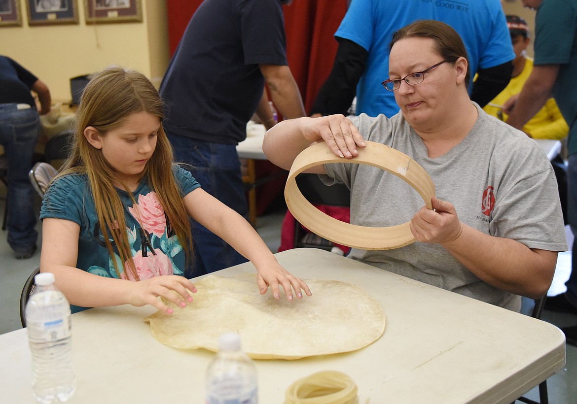 DRUM MAKING can be a family activity, such as when Amy Williams and her daughter Arlonna Christopher of Polson worked together preparing their tanned hide to be attached to the cedar drum frame.