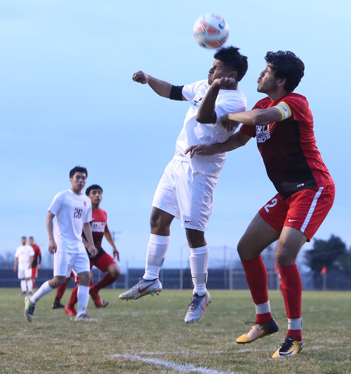 Connor Vanderweyst/The Sun Tribune
Othello&#146;s Carlos Murillo (red) challenges a Toppenish player for a ball in the air.