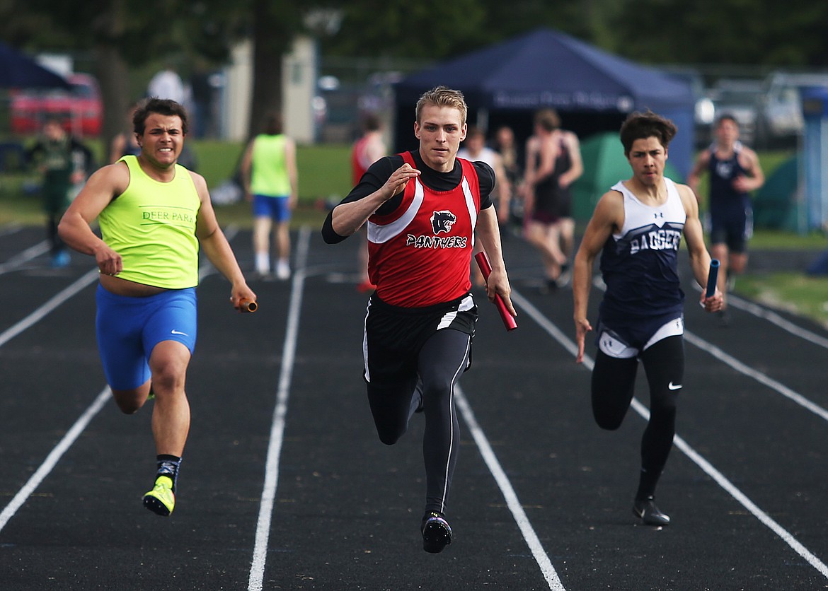 Coeur d&#146;Alene Charter&#146;s George Dundas, center, strides toward the finish line in the 4x100-meter relay at the Timberlake Invitational.