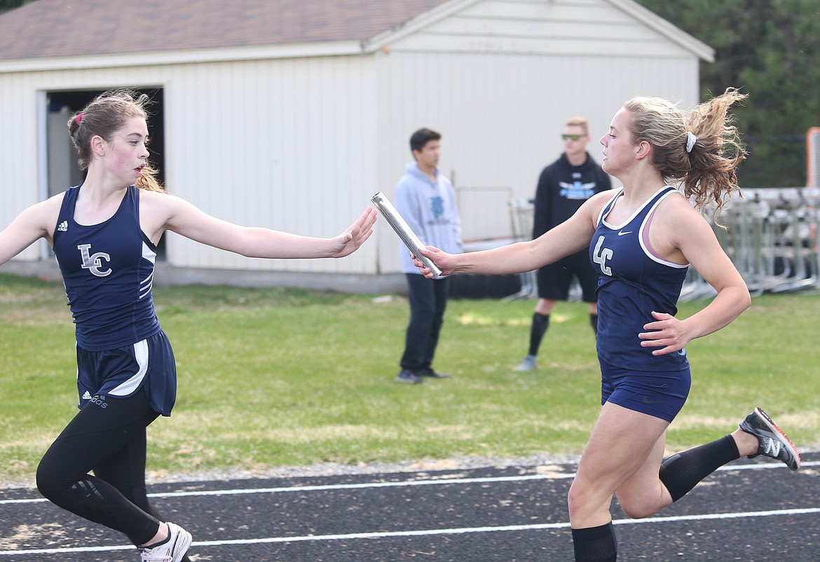 Lake City&#146;s Maddie Quigley passes the baton to Ainsley Lanigan in the 4x200-meter relay during the Timberlake Invitational.
