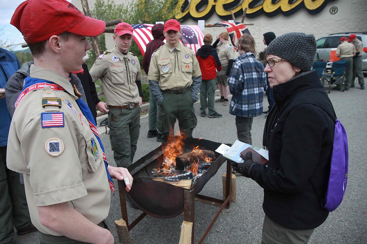 RALPH BARTHOLDT/Press
Boy Scouts Inland Council CEO Karen Meier (right) quizzes Scout Ryan Merritt of Troop 201 on the etiquette of flag retirement as fellow Scouts look on.