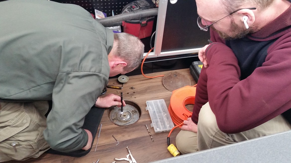 (Photo by MARCIE GARCIA)
The crew from North Idaho Lock and Key worked for several hours to crack open the mysterious floor safe at Sandpoint Super Drug on Thursday.