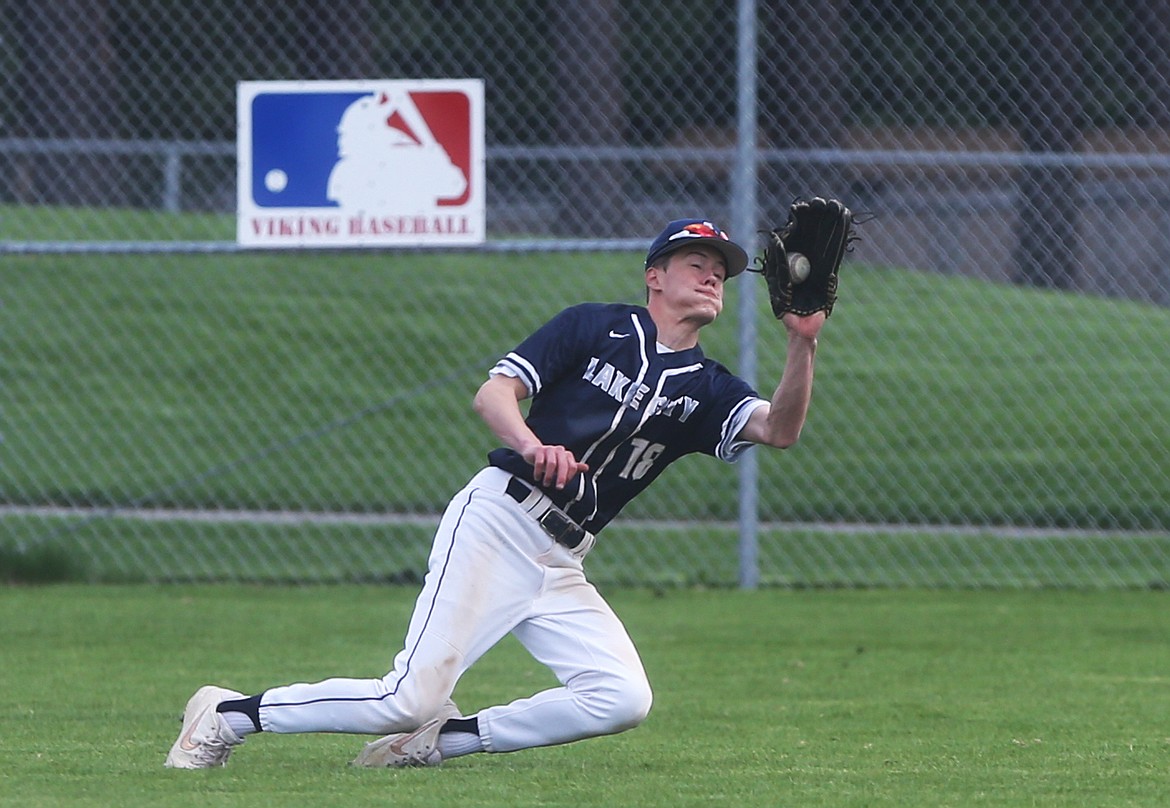 Lake City center fielder Brennen Schuelke makes a diving play on a fly ball in Tuesday&#146;s game against Coeur d&#146;Alene. (LOREN BENOIT/Press)