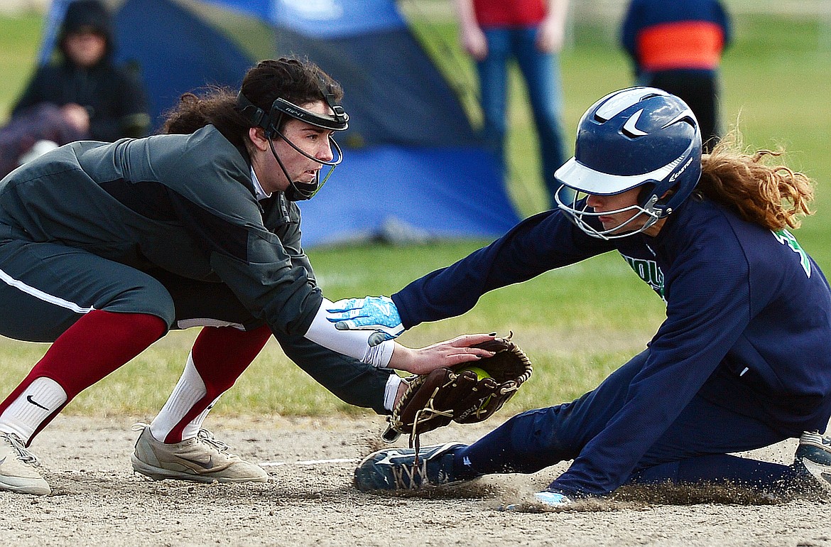 Glacier&#146;s Kira Barney is tagged out at third base by Helena&#146;s Vanessa Walsh in the fourth inning at Glacier High School on Saturday. (Casey Kreider/Daily Inter Lake)