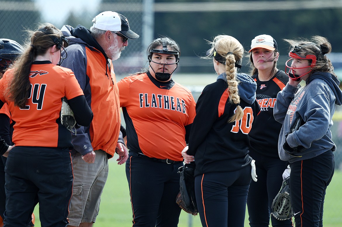 Flathead coach Jack Foster meets with his team on the mound in the fourth inning against Helena Capital at Kidsports Complex on Saturday. (Casey Kreider/Daily Inter Lake)