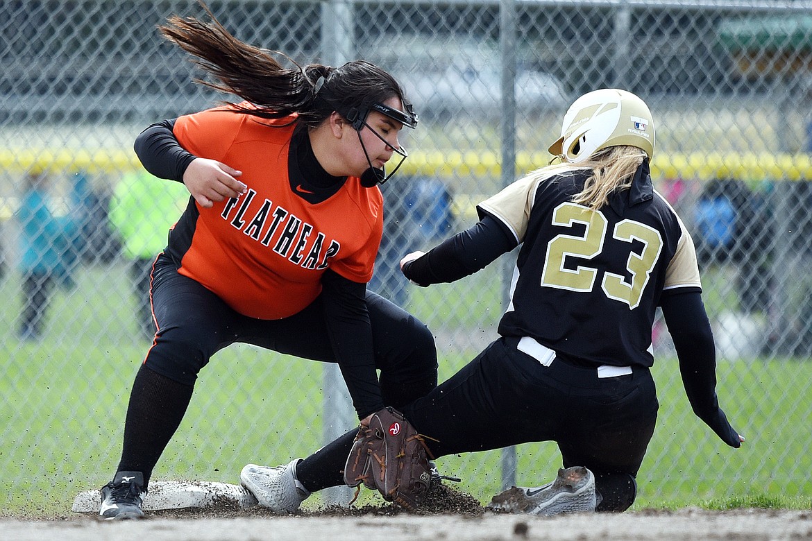 Helena Capital&#146;s Lauren Archie (23) slides into third ahead of the tag by Flathead third baseman Brianna Morales in the first inning at Kidsports Complex on Saturday. (Casey Kreider/Daily Inter Lake)