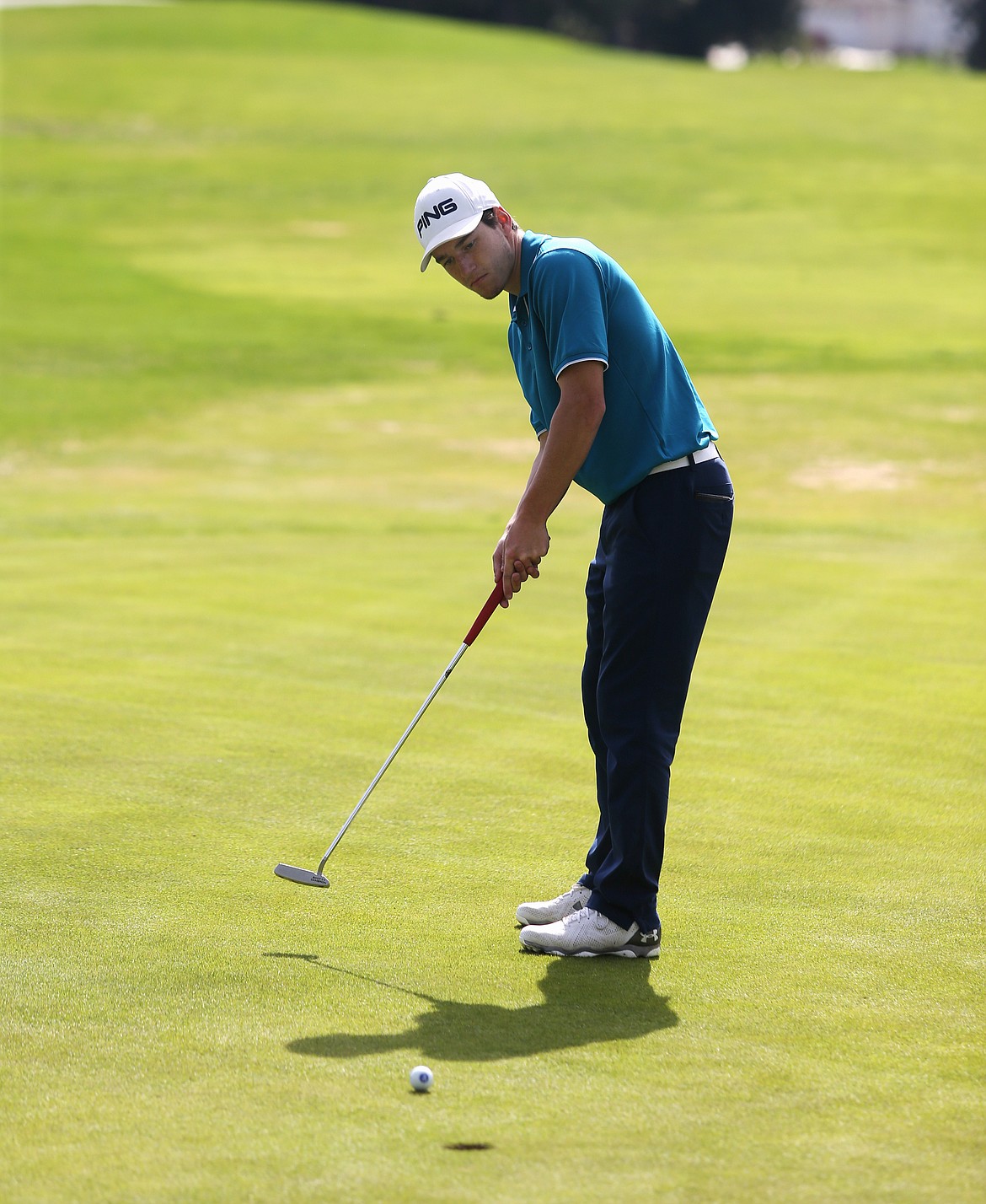 Photos: LOREN BENOIT/Press 
Lake City High&#146;s Cameron Johnson watches his putt roll into the 18th hole during the Post Falls Invitational Monday morning at The Highlands. Johnson earned medalist honors with a 1-under-par 71.