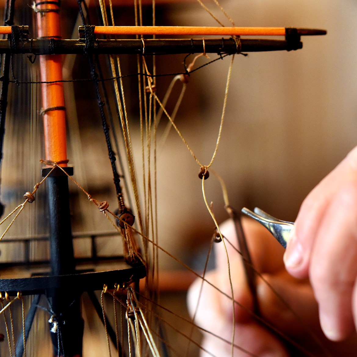 Allen Daffern uses tweezers to put in the rigging of the HMS Leopard on Thursday, April 11, at his home in Kalispell. Daffern&#146;s interest in boat building comes from history and aesthetics. &#147;I&#146;ve never built a ship I have no interest in,&#148; said Daffern. The Leopard mainly served in the French Revolutionary Wars and the Napoleonic Wars, however, it does make an appearance in American Naval history. In 1807 the captain of the Leopard asked permission of the USS Chesapeake to board and search for deserters. The Chesapeake declined, and the Leopard opened fire. The incident is known as the Chesapeake-Leopard Affair and nearly resulted in war.
(Brenda Ahearn/Daily Inter Lake)