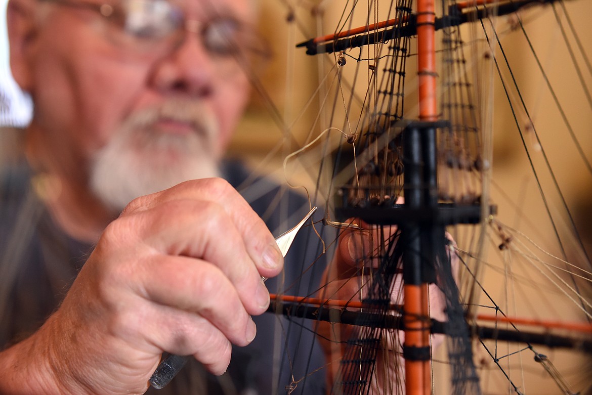 Daffern uses tweezers to put in the rigging of the HMS Leopard. He said that rigging the ships requires time and patience. Daffern estimated that there is at least a quarter of a mile of thread on his model of the HMS Victory.