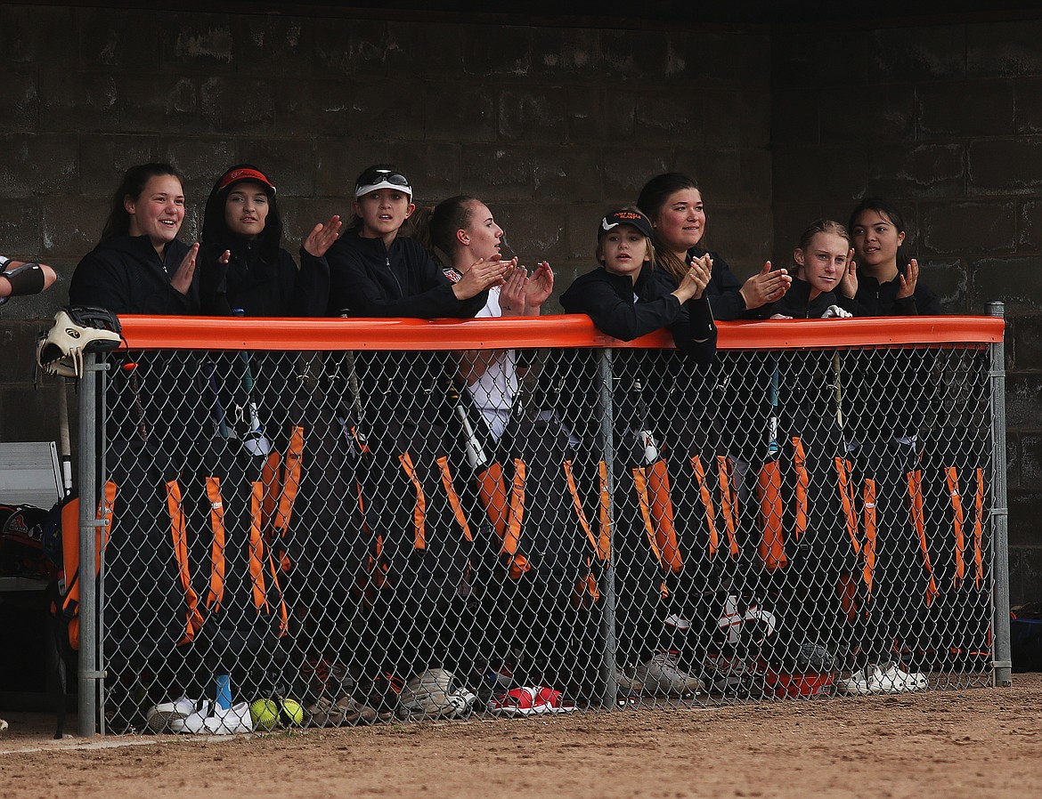 Post Falls High School varsity girls softball team members cheer from the dugout for a teammate during an at-bat in a game against Lake City last Tuesday in Post Falls.