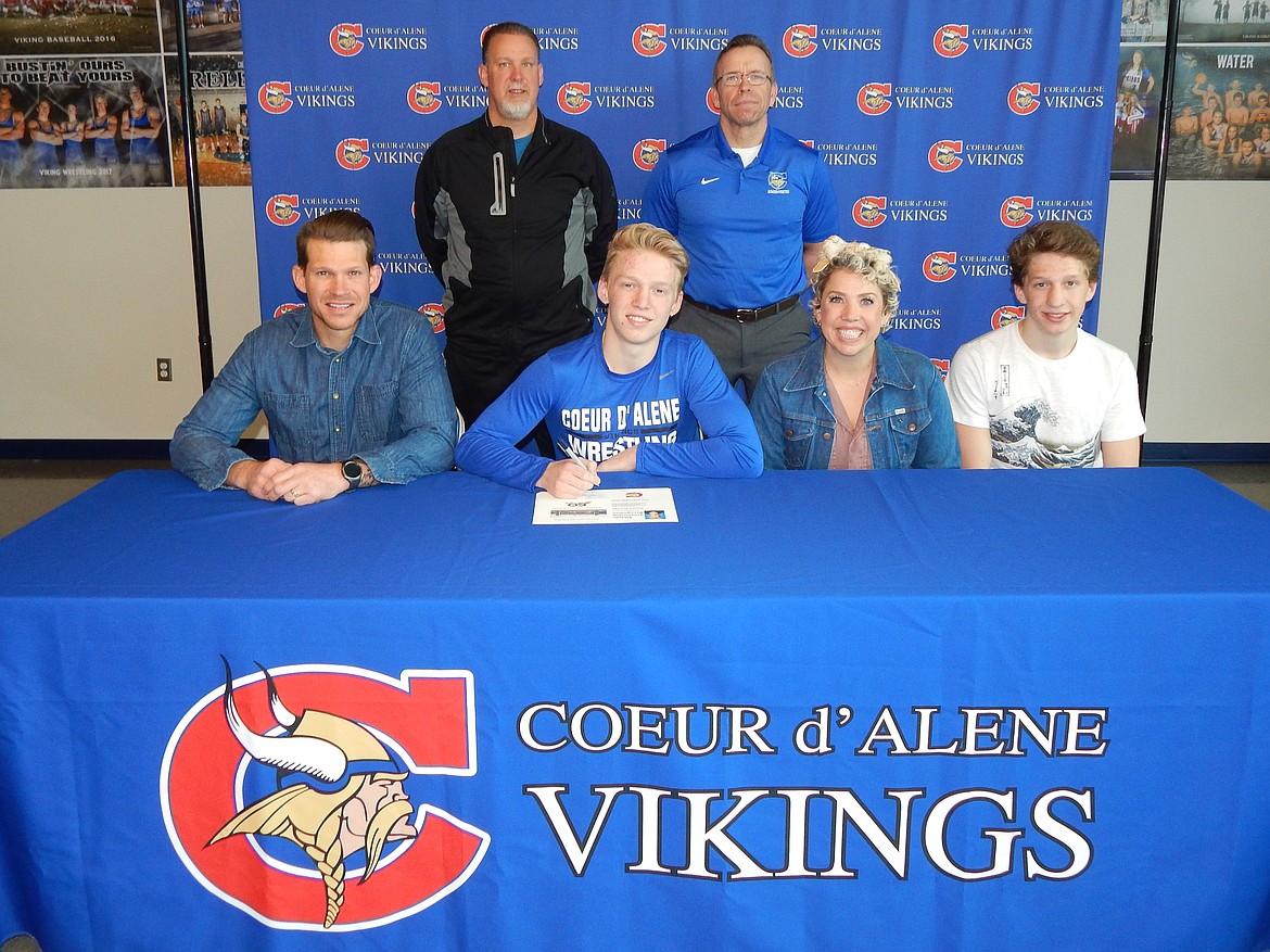 Courtesy photo
Coeur d&#146;Alene High senior Payton Keough recently signed a letter of intent to wrestle at NAIA Eastern Oregon University in La Grande. Seated from left is Sean Keough (dad), Payton Keough, Toby Keough (mom) and Mason Keough (brother); and standing from left, Jeff Moffat, Coeur d&#146;Alene High head wrestling coach; and Mike Randles, Coeur d&#146;Alene High athletic director.