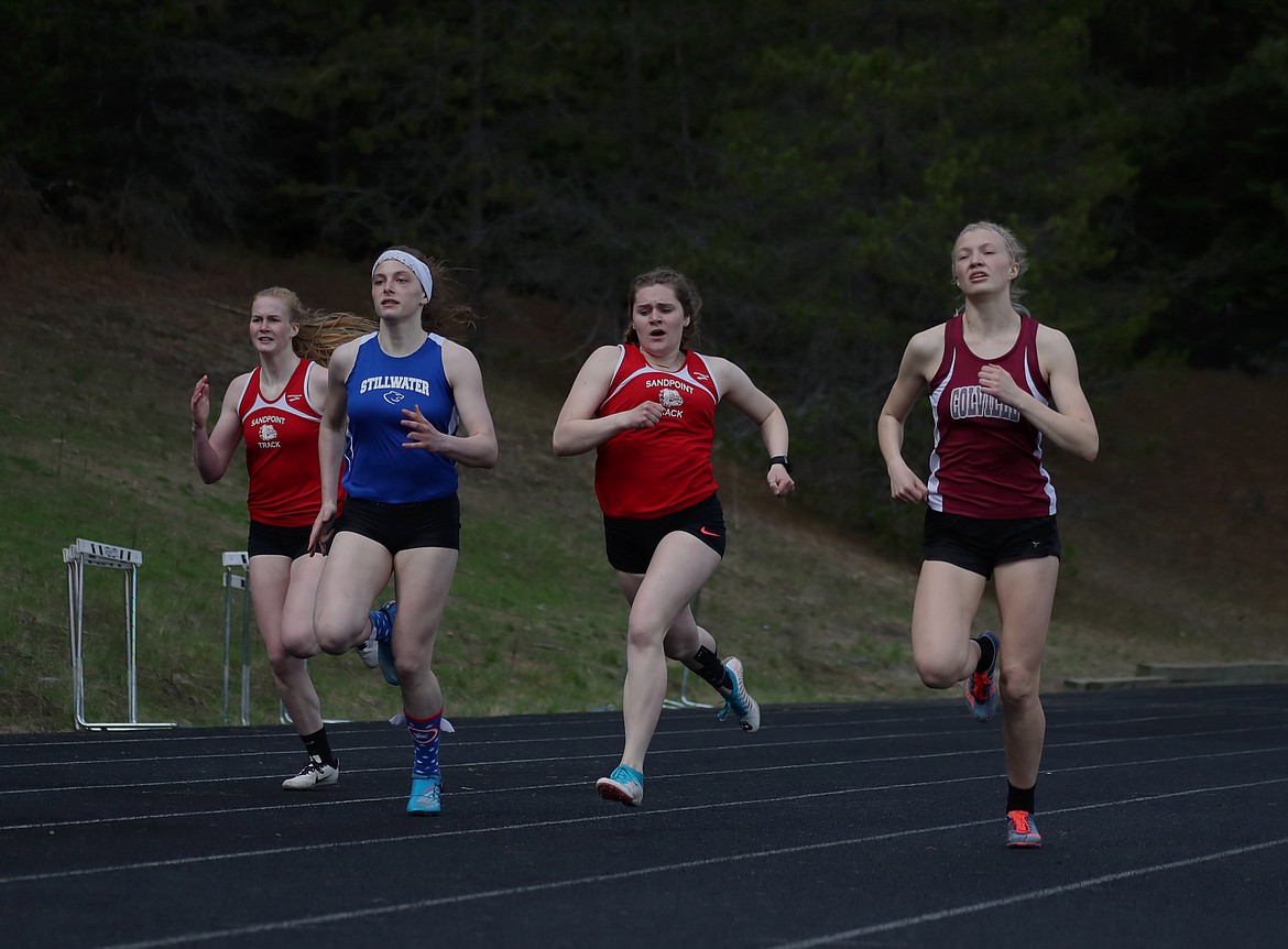KYLE CAJERO/Bonner County Daily Bee
From left, Sophia Platte (Sandpoint), Aleeya Derlakta (Stillwater Christian), Valerie Wickboldt (Sandpoint) and Evonne Stehr (Colville) compete in the girls 200 meters at the Priest River Invitational on Saturday.