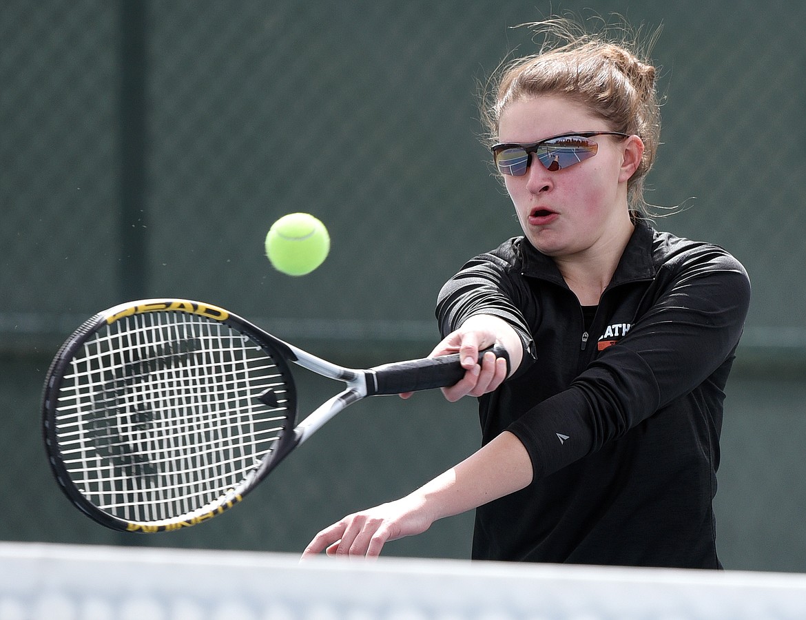 Flathead's Sierra Dilworth hits a return in a doubles match with teammate Marcella Mercer against Bigfork's Dana Sarri and Callie Martinez at Flathead Valley Community College on Tuesday. (Casey Kreider/Daily Inter Lake)