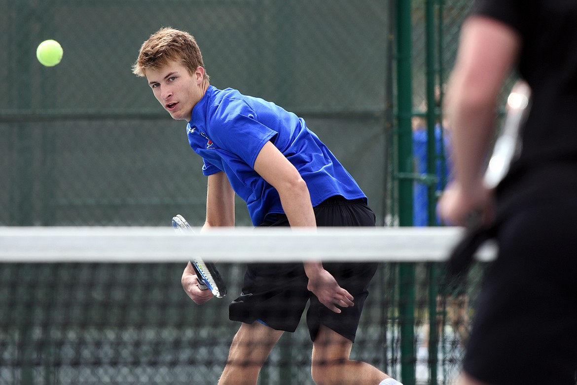 Bigfork's Colton Reichenbach hits a return in a doubles match with his brother Clayton against Flathead's Nolan White and Brett Thompson at Flathead Valley Community College on Tuesday. (Casey Kreider/Daily Inter Lake)