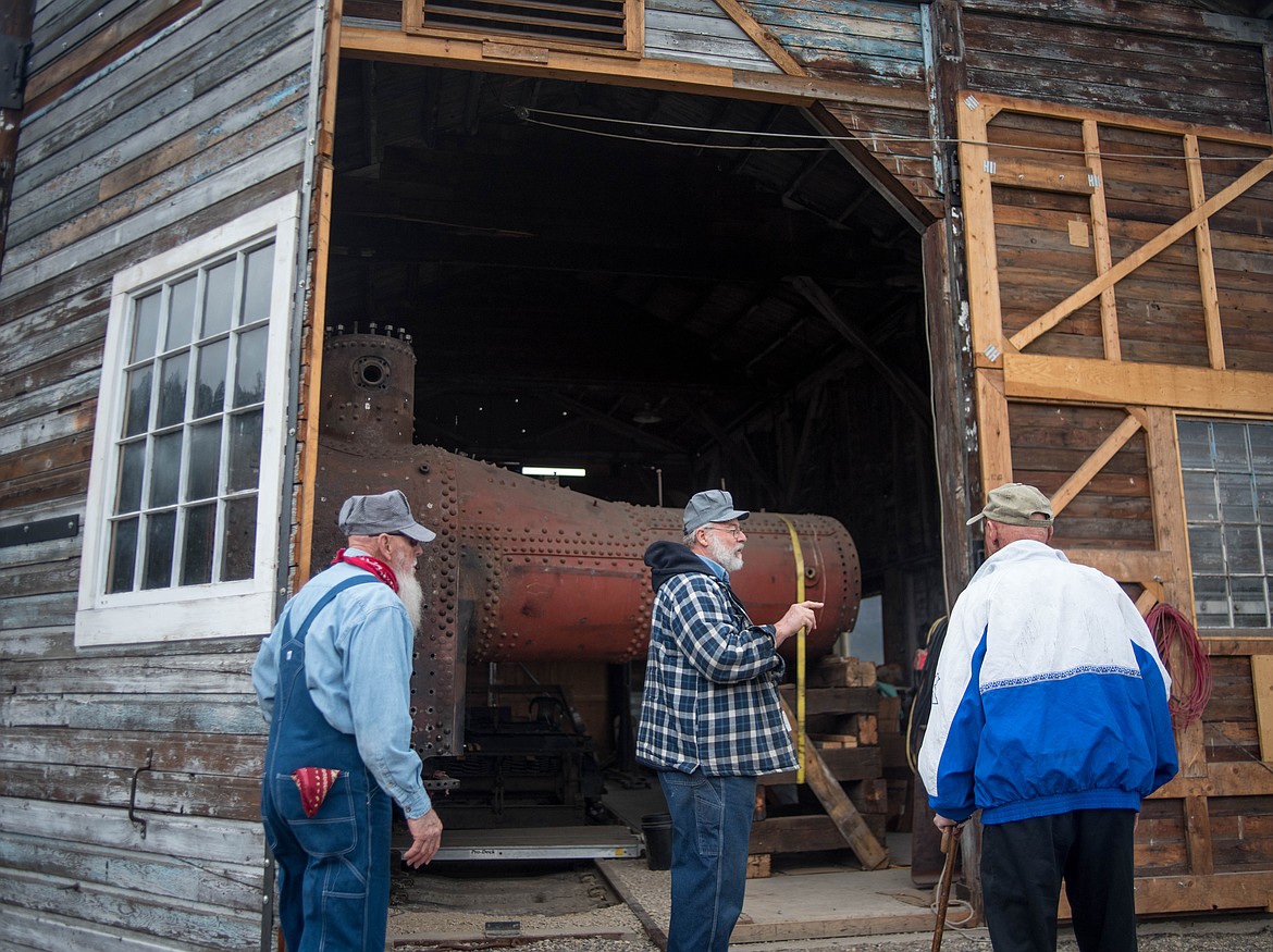 (From left to right) Heritage Museum volunteers Ron Numerick, August Hardgrove and Clarence Johnson hang out in front of a Shay locomotive they have all been repairing, April 18 at the museum in Libby. (Luke Hollister/The Western News)