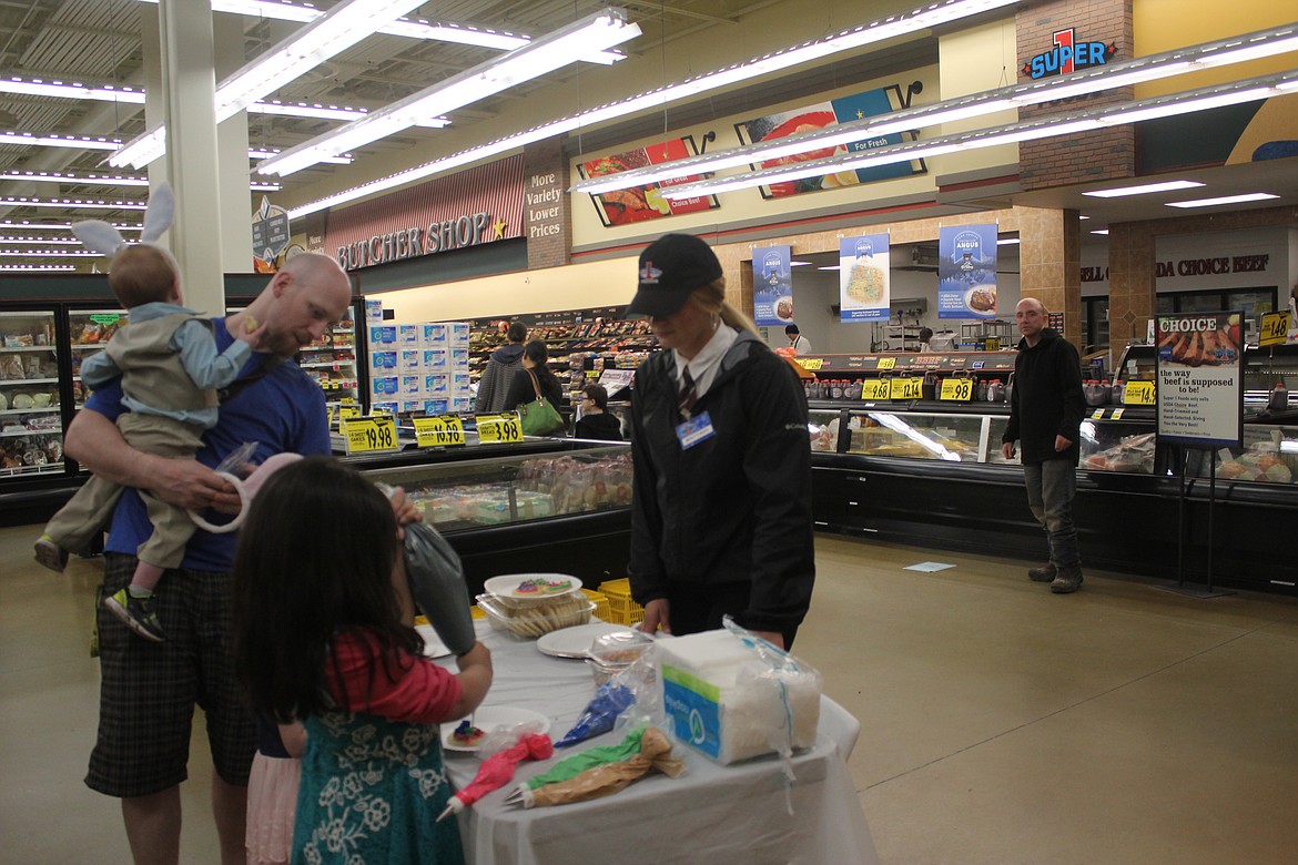 Dad John Heigel, brought his kids Kaulder and Temari to the celebration at Super 1 and allowed them to decorate cookies.