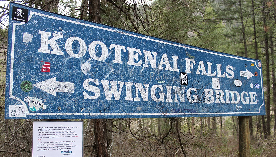 A sign points visitors to the swinging bridge that has spanned a stretch of the Kootenai River nearly continuously since the 1930s. Contractors working for the U.S, Forest Service started work April 1 to build a new bridge.