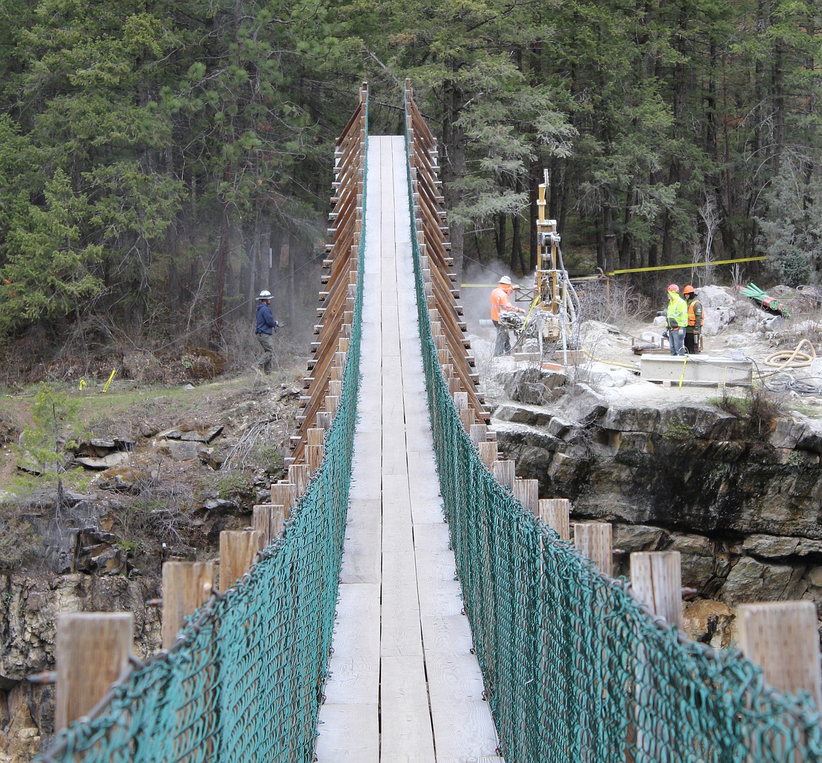 Work is underway to replace the swinging bridge over the Kootenai River at a site along U.S. 2 between Libby and Troy. (Duncan Adams photos/Daily Inter Lake)