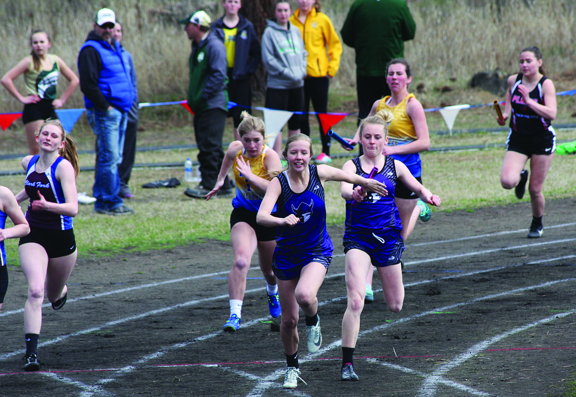 CHARLO HIGH School sophomore Carley Fryberger accepts the baton from teammate Kaitlin Cox during the Thompson Falls Invitational Tuesday at Thompson Falls High School. Cox and Fryberger have become two of the premier track participants in Class C in the western portion of Montana. (Photo courtesy of Sheri Delaney)